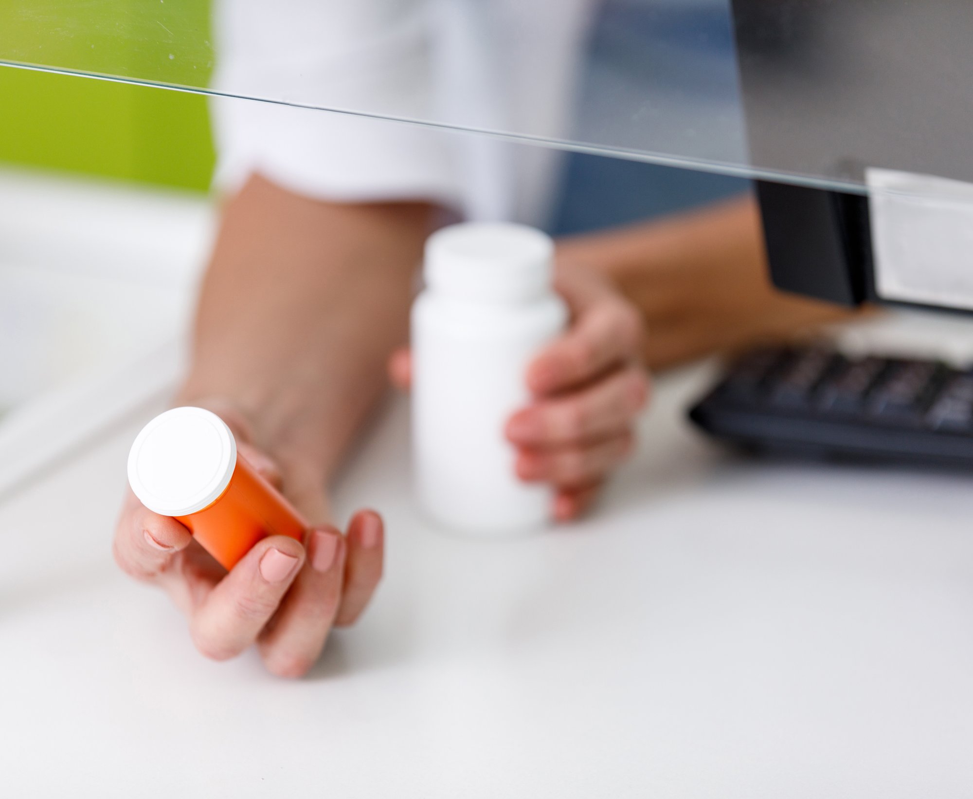 cropped-shot-of-pharmacist-holding-containers-with-2024-11-18-15-46-52-utc